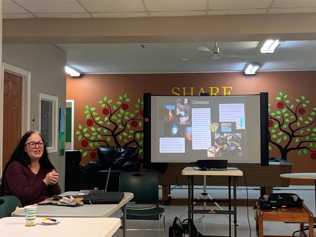 lady presenting to a group in a classroom setting 