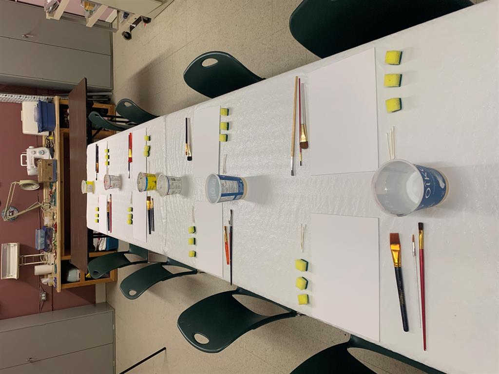 A table set up with painting supplies 