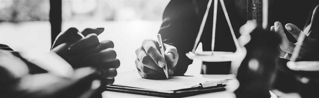 photo of two people doing paperwork at a desk 